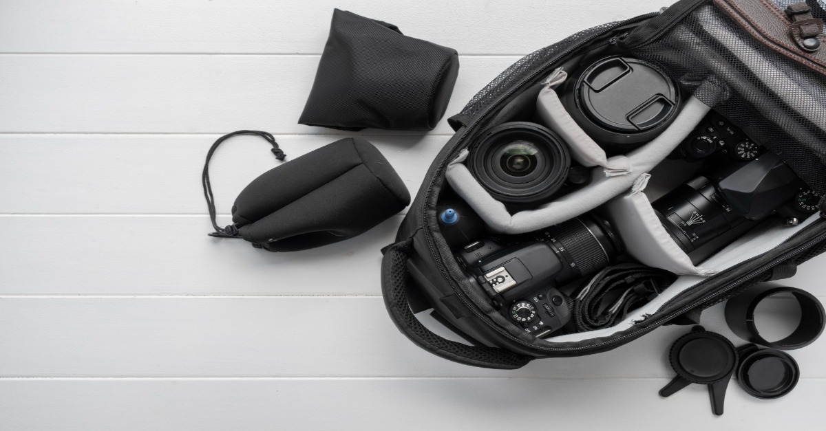 A camera bag containing a camera, lens, and accessories, showcasing essential video production equipment for beginners.