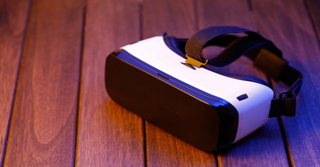 Virtual reality headset resting on a wooden table, showcasing the latest in VR technology.