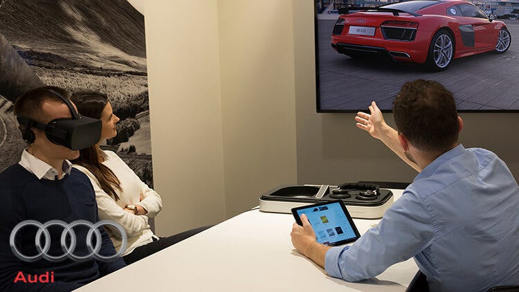 Audi using virtual reality for customer experience highlighting innovative features during a product demonstration.