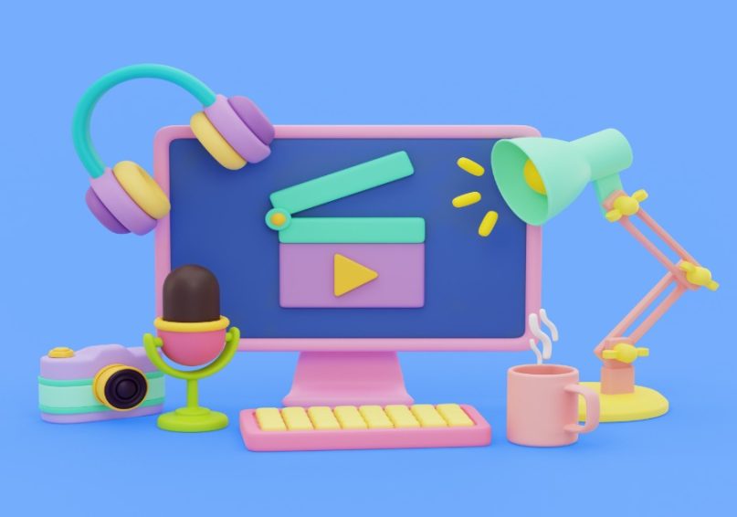 A computer displaying a video icon and various items, highlighting trends in corporate video production for 2025.