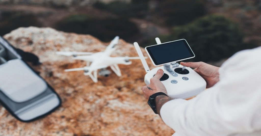 A person setting up drone for practicing smooth movements for effective drone videography. 