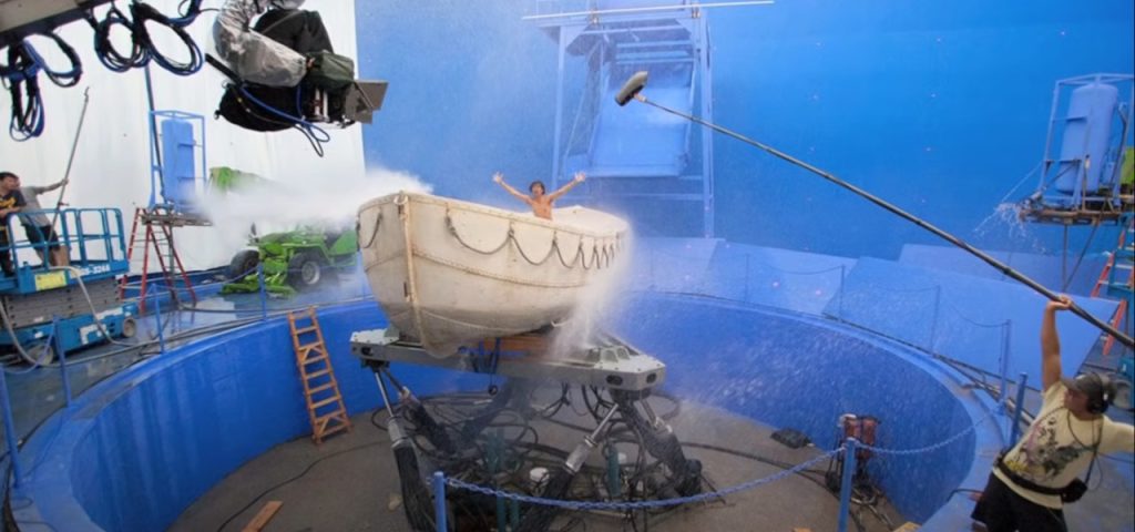 A man sprays water on a boat in a studio, showcasing VFX techniques for digital isolation in rotoscoping.