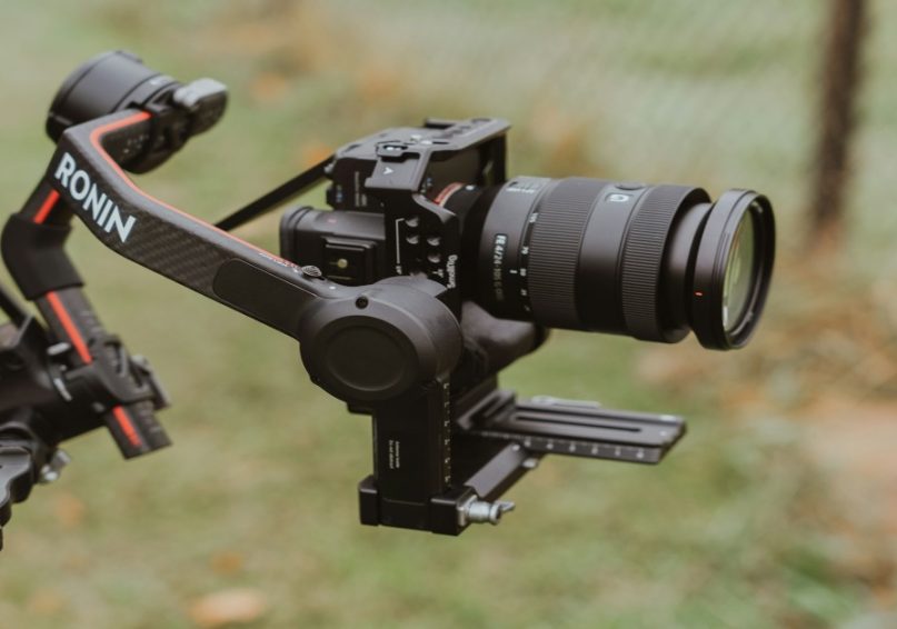 A person holding a gimbal, to showcase gimbals are essential for smooth shots.