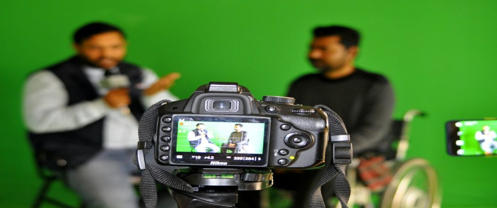 A camera set up in front of a green screen, ideal for creating dynamic corporate video content.